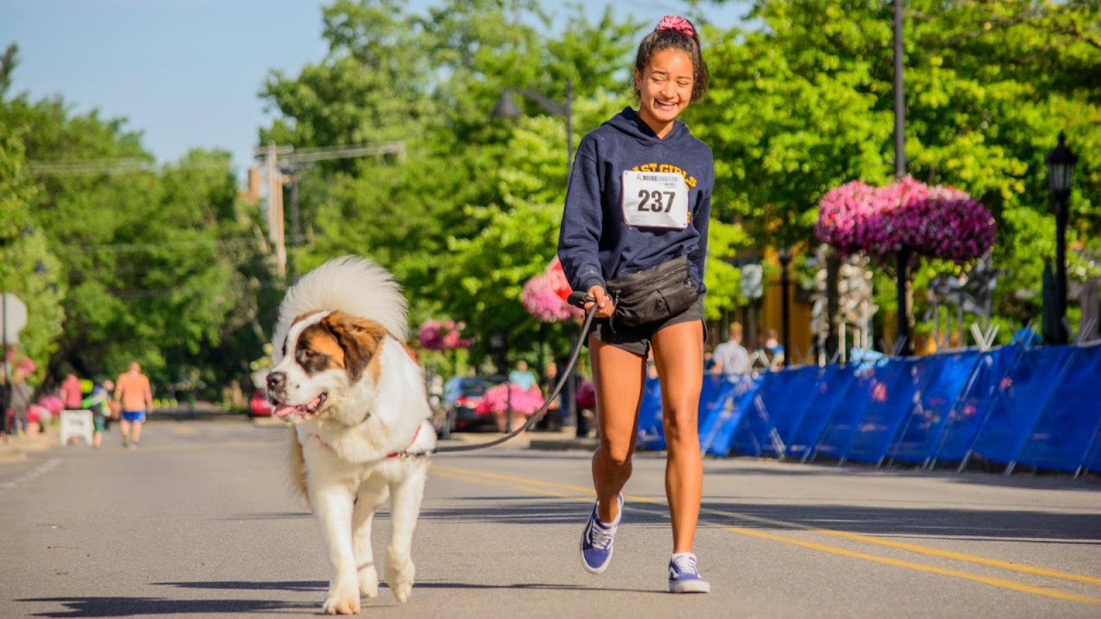 Girl walking dog at Reeds Lake Run