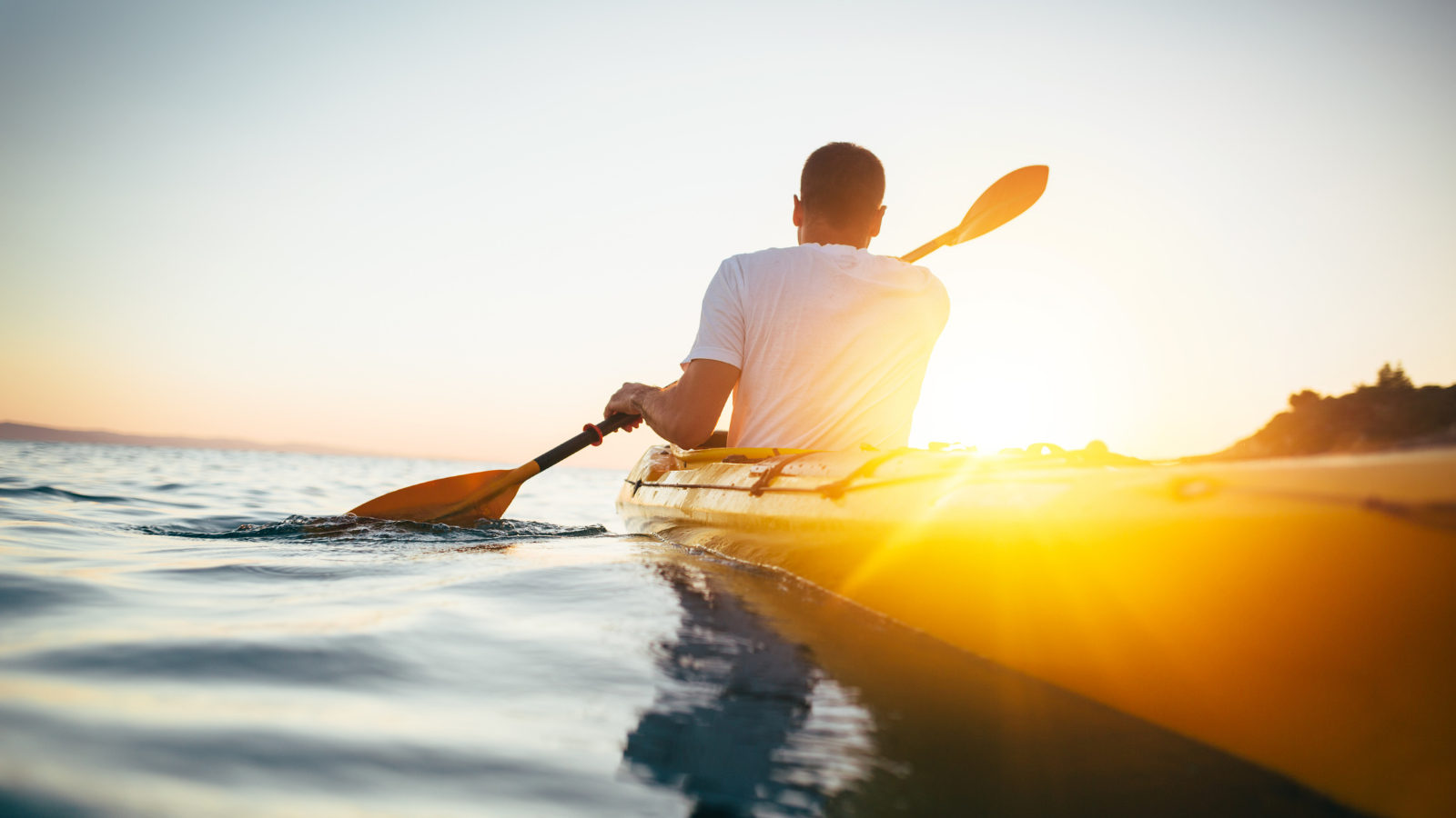 Man kayaking on sunny day