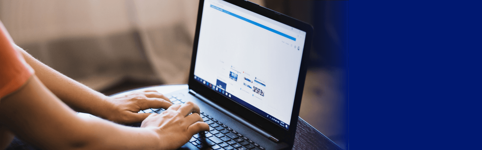 Hands typing on a laptop with blue overlay